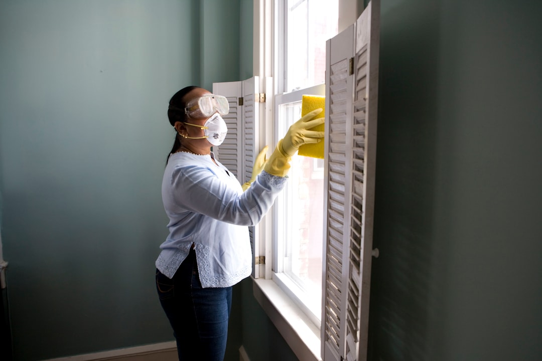 about-us When renovating a home, you should use a damp sponge or cloth to clean dust collected on a window sill, as the dust may contain asbestos or lead-based paint. Home maintenance is an ongoing process for any homeowner, and here we see an African- American woman who’d taken a damp sponge to her window’s frame, in order to remove accumulated dust particulates. Note how the homeowner had donned a pair of waterproof gloves, a facemask, and a pair of goggles, prior to beginning this task.
